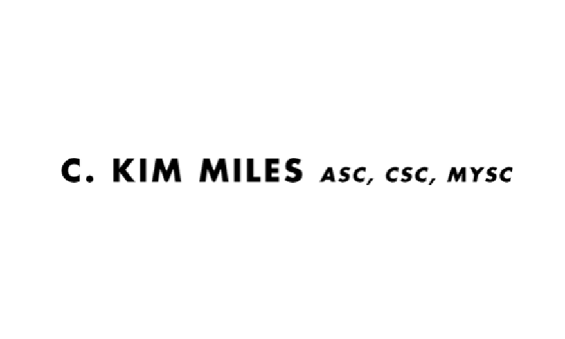 A black and white photo of the kim miles logo.