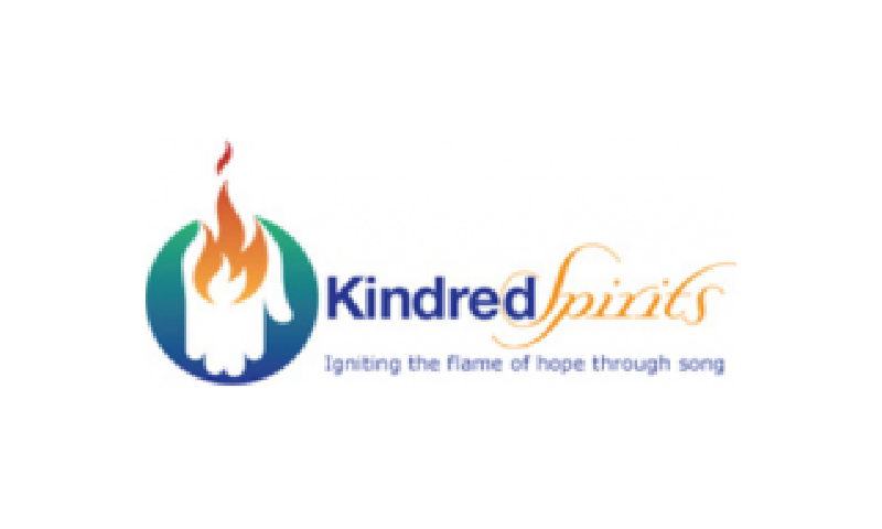 A logo for kindred spirits, an organization that is dedicated to igniting the flame of hope through song.