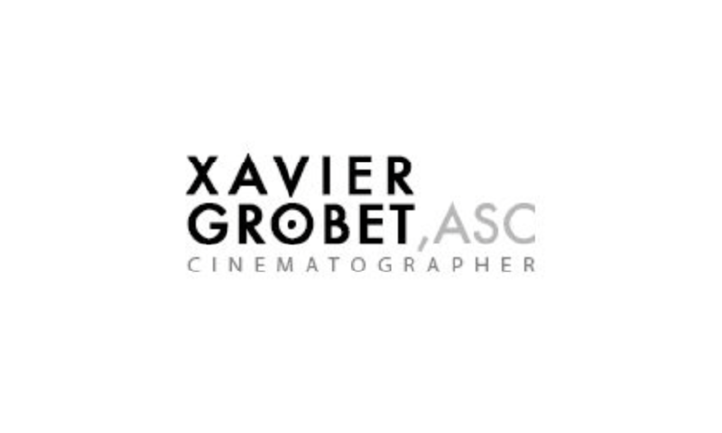 A black and white photo of the logo for xavier grobet, asc.
